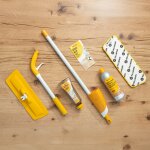 Der gesamte Lieferumfang des Pallmann Spraymop Sets liegt auf einem hochwertigen Holzboden. Der Wischmopp ist in seine Einzelteile zerlegt. Daneben liegt die Gebrauchsanweisung, der Parkettreiniger und das Spraymop Pad.